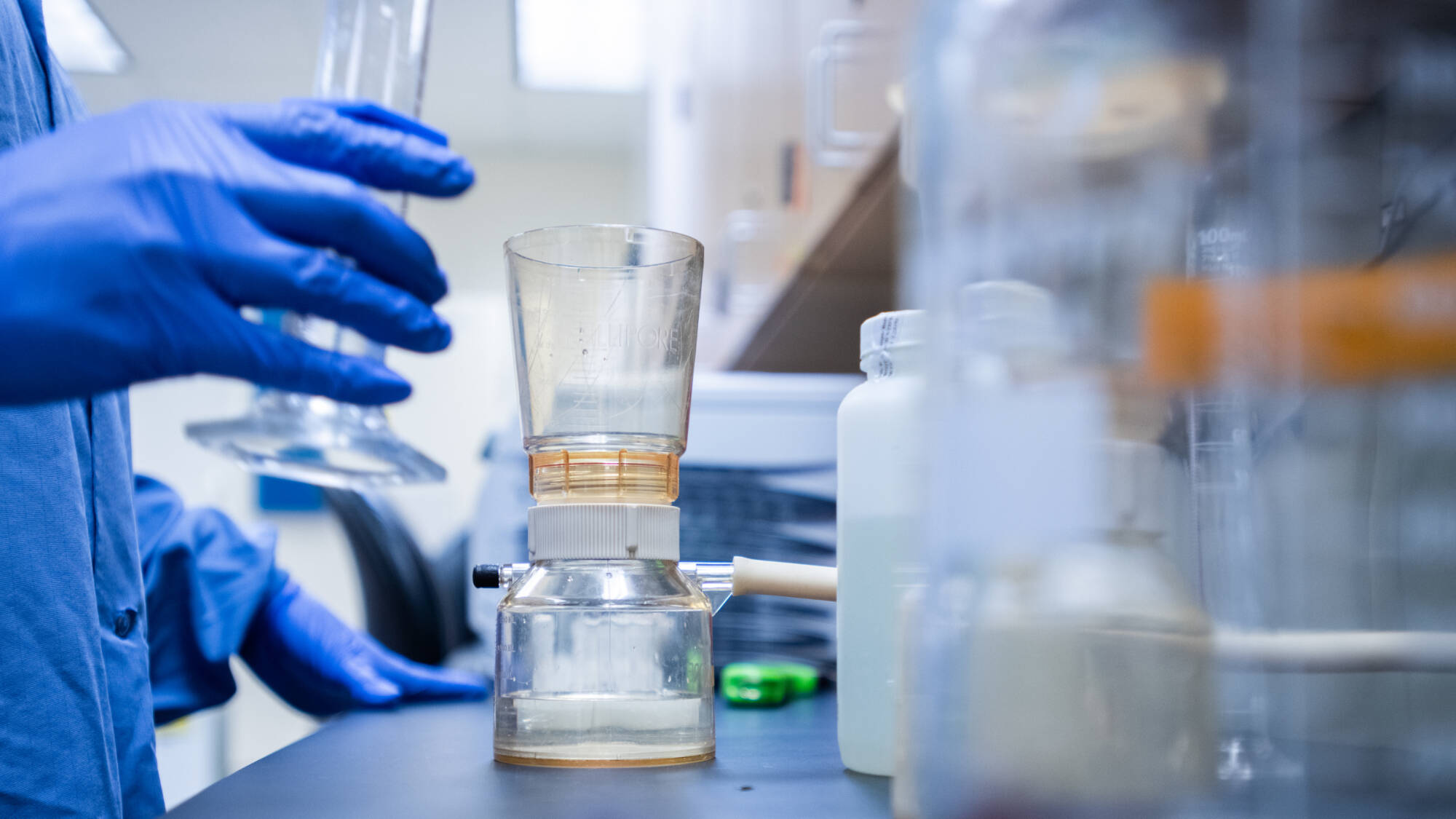 Using a graduated cylinder for measurement.